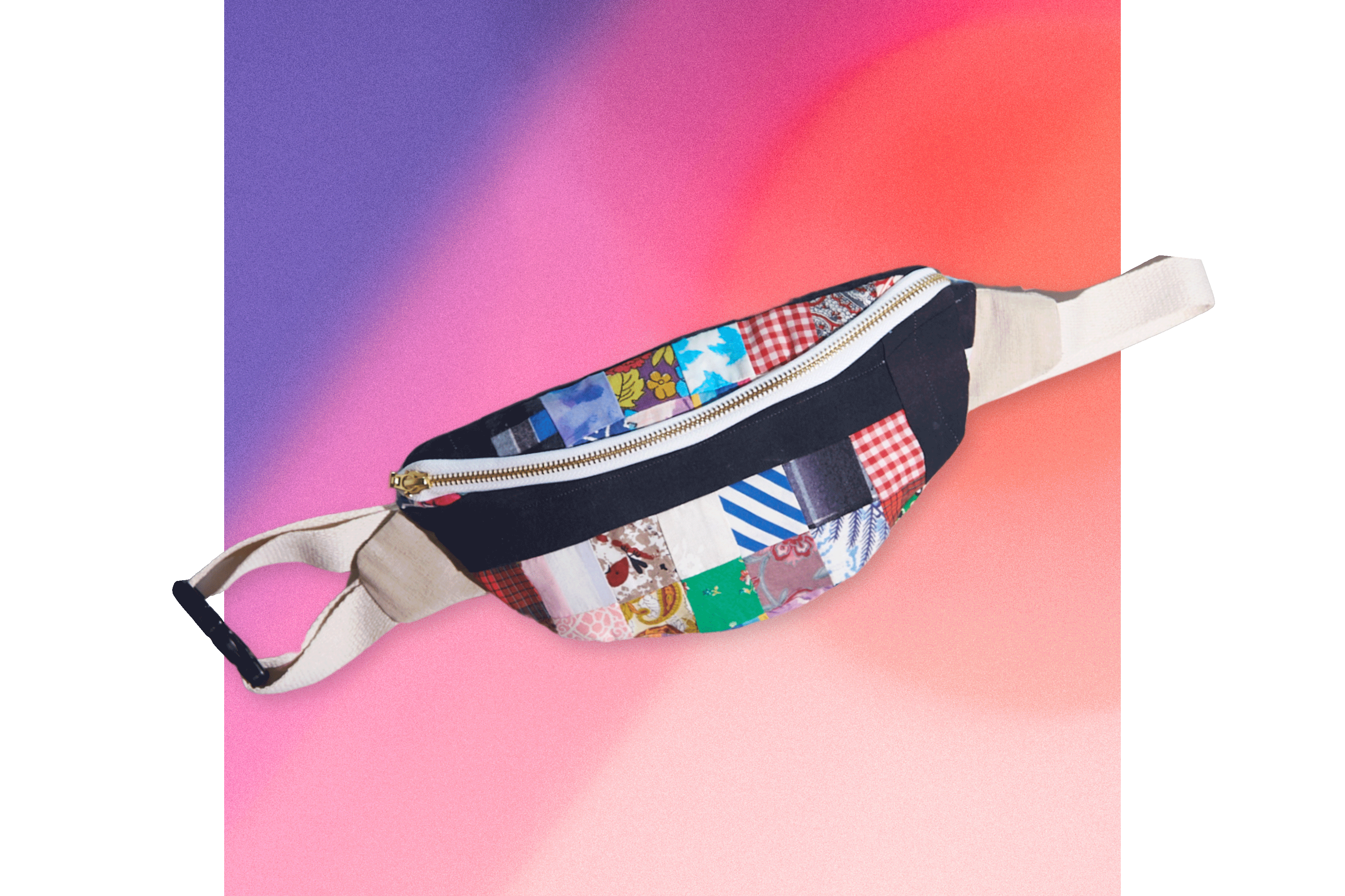 Colorful patterned belt bag made from upcycled tablecloth patchwork on a gradient background