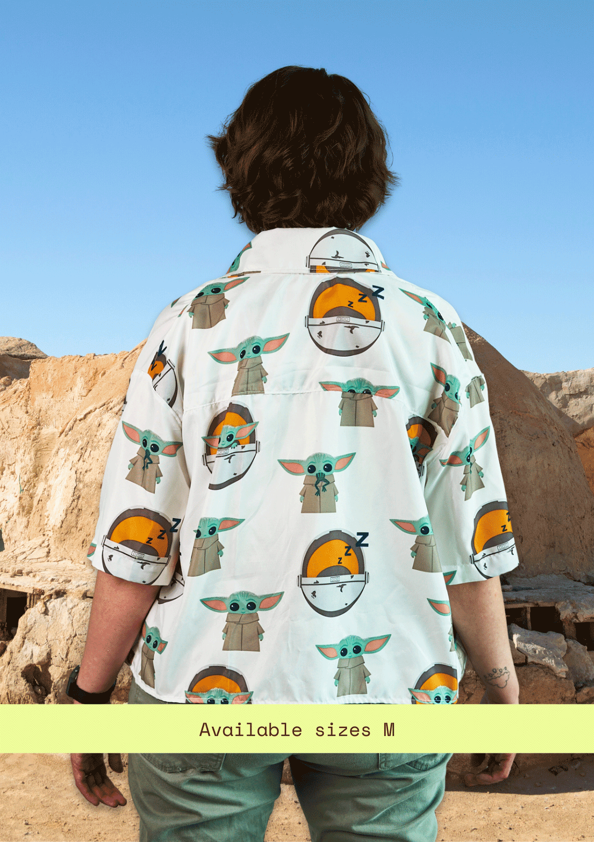 Person wearing an upcycled shirt with 'The Child' pattern in a desert setting
