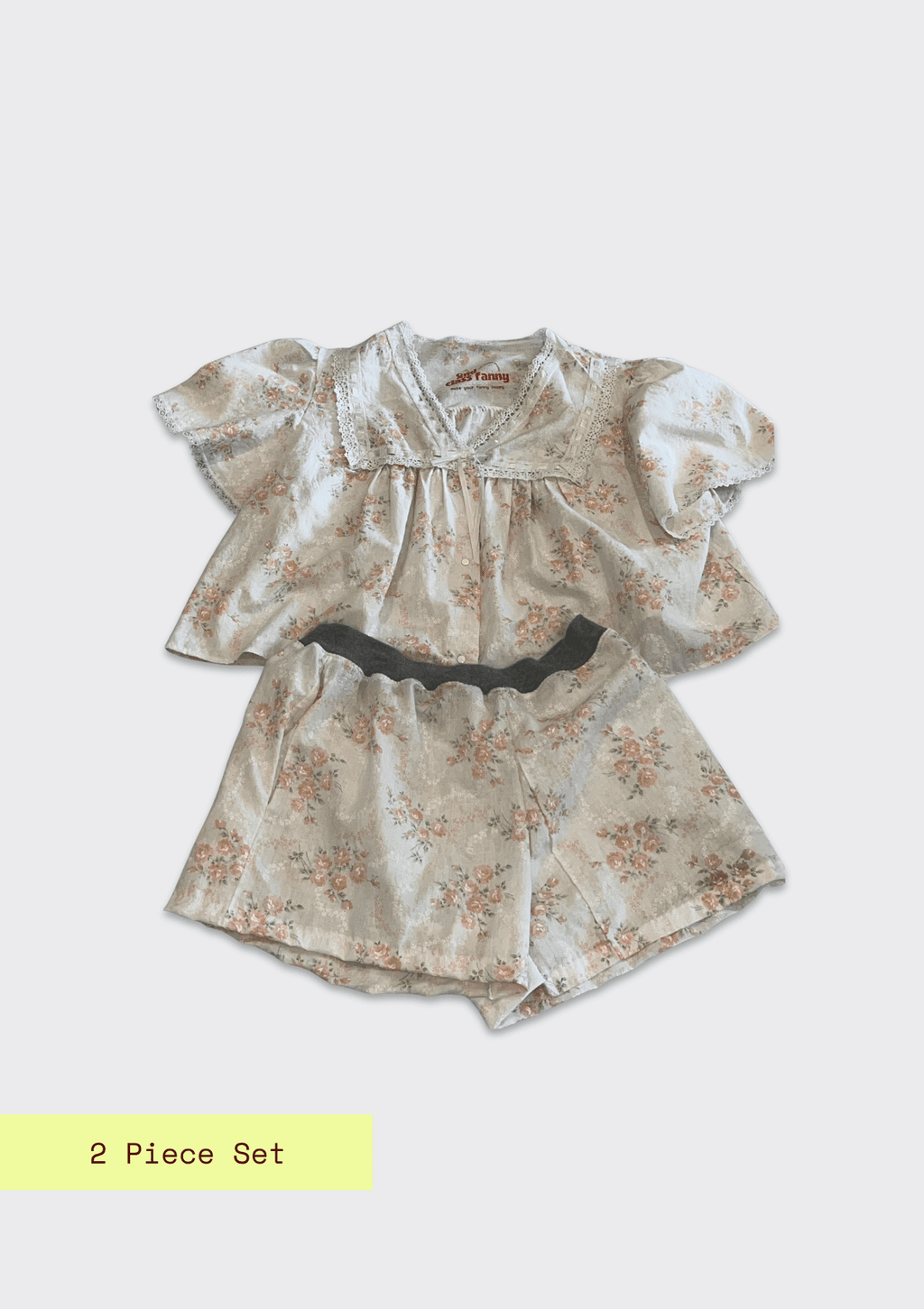 Two-piece floral outfit with ruffled sleeves on a light gray background