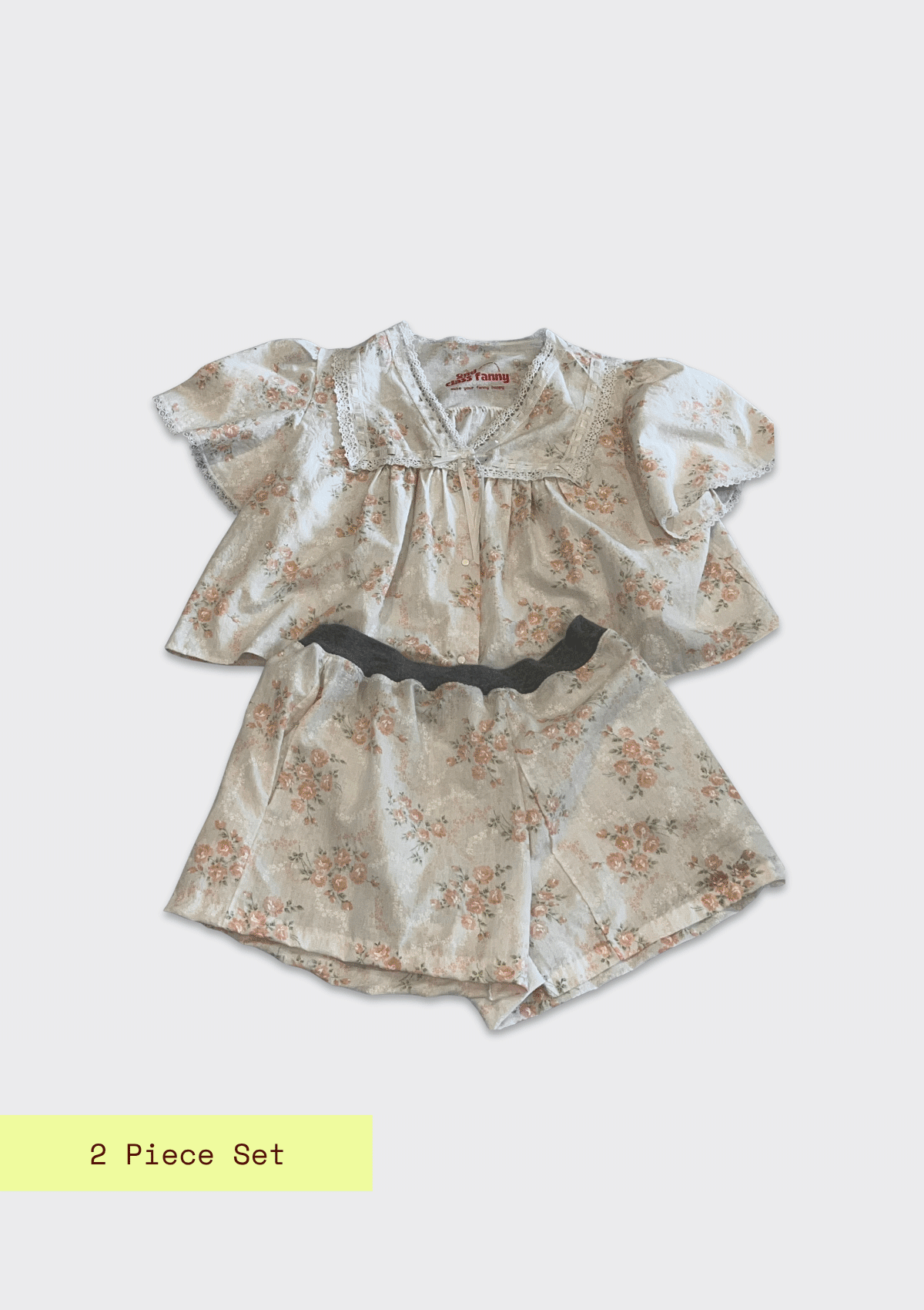 Two-piece floral outfit with ruffled sleeves on a light gray background