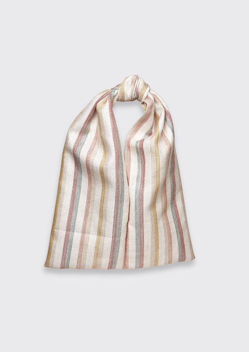 Striped bag tied in a knot upcycled form designer deadstock fabric on a light gray background