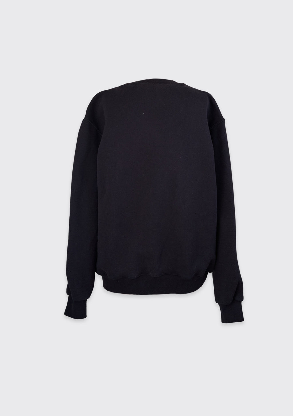 Black sweatshirt upcycled from a crew neck, curtains, and a Nike tank, on a light gray background