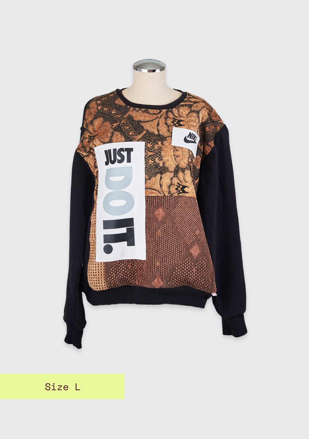A reworked crew neck pullover with gold pattern with the words just do it against a grey background