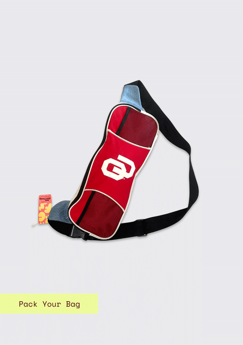 Red and white OU bike messenger bag on a light gray background