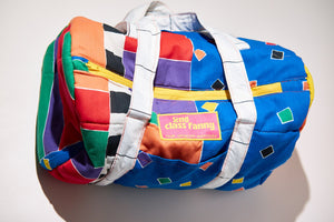 Colorful backpack with geometric pattern upcycled from comforter on a white background