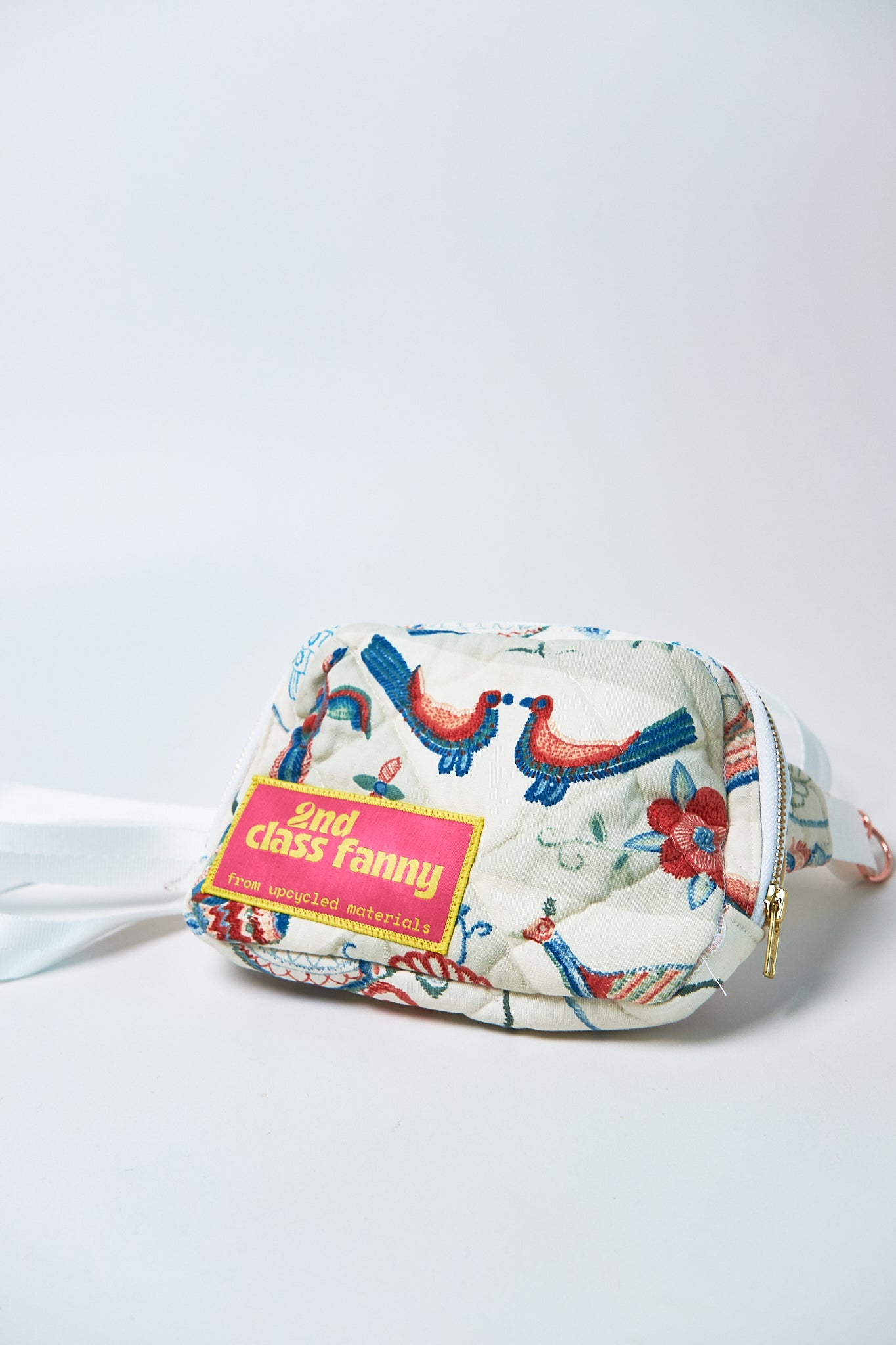 Fanny pack with floral design upcycled from a quilt and '2nd class fanny' label on a white background