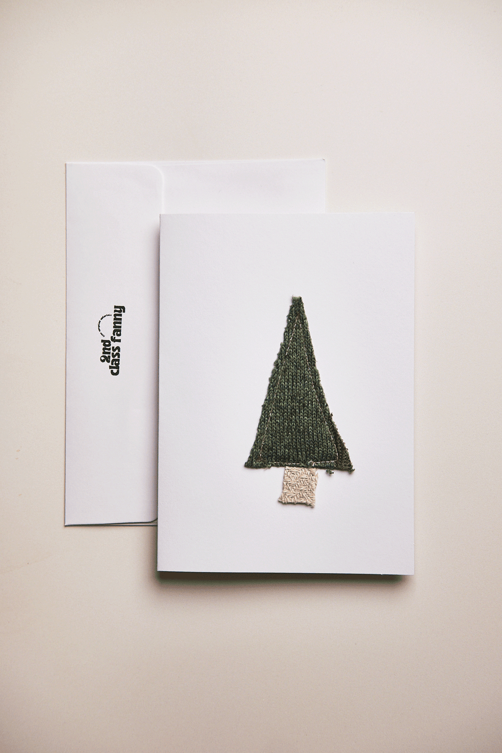 Greeting card with a green tree design on a beige background
