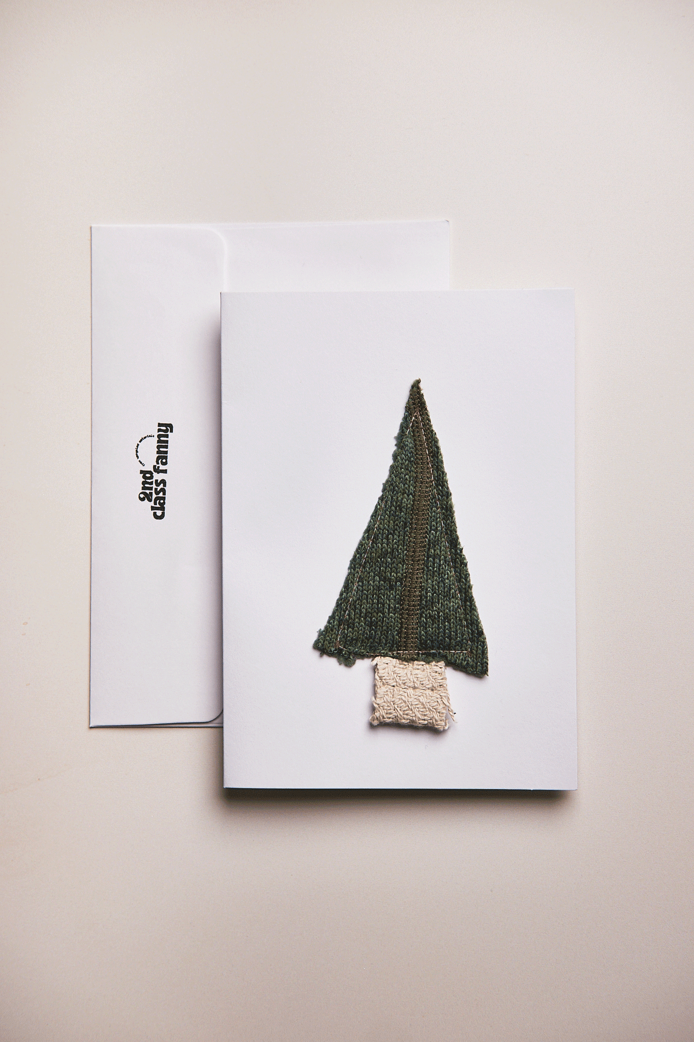 Christmas Tree on a card with a white envelope on a beige background