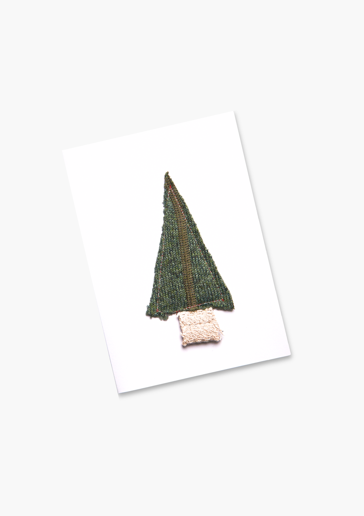 Knitted green Christmas tree on a white card