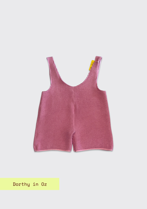 Pink checkered romper on a light gray background with 'Dorthy in Oz' text.