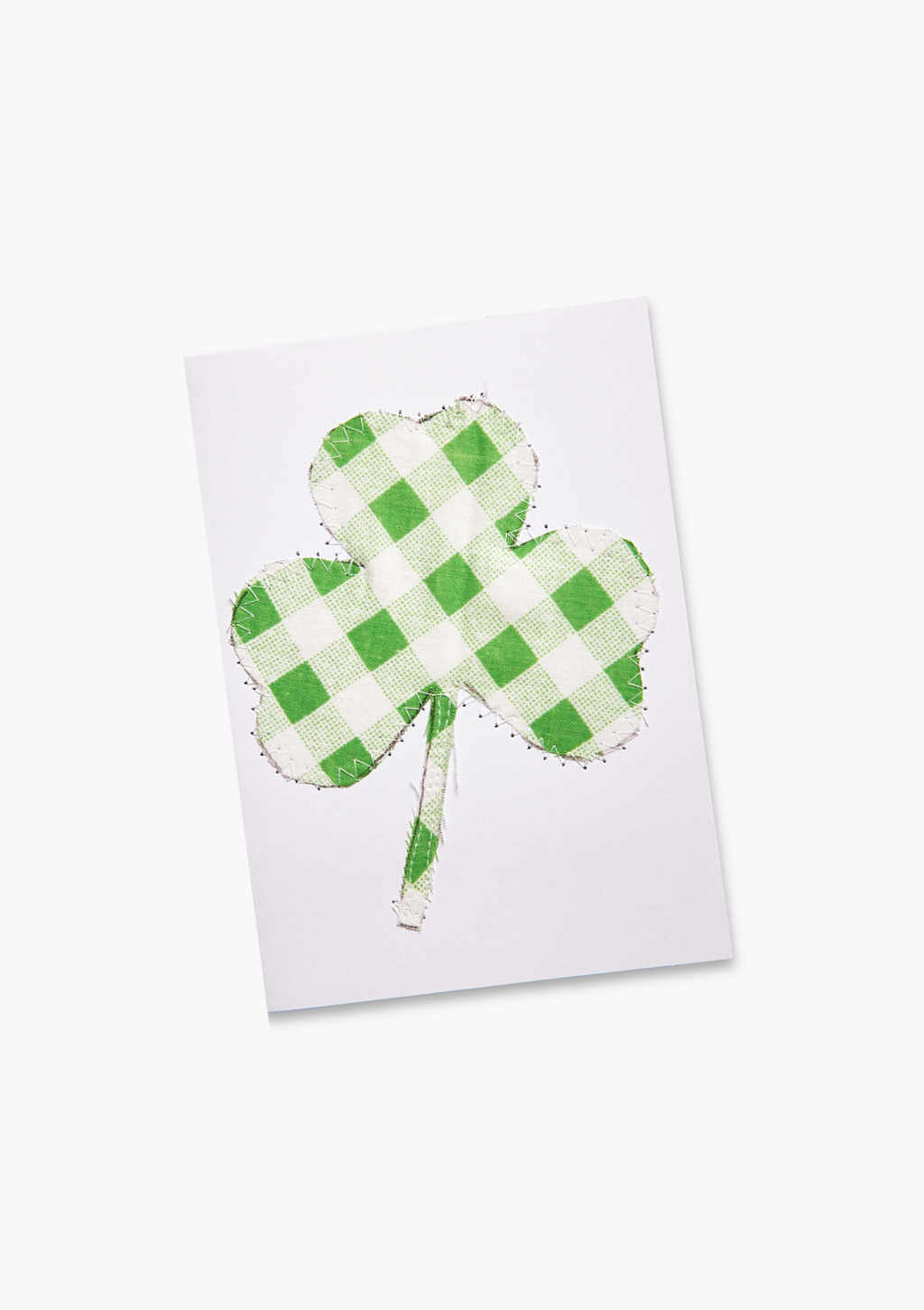 Green checkered shamrock on a white card made from upcycled bed sheets
