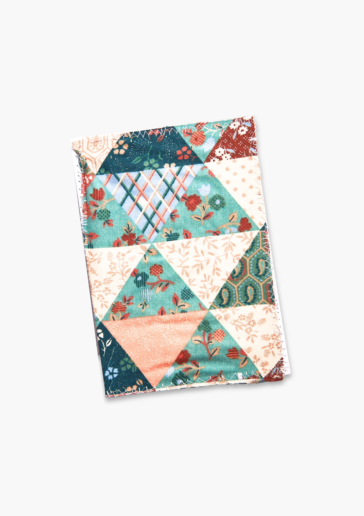 Card made from upcycled from a patchwork quilt with geometric patterns on a white background