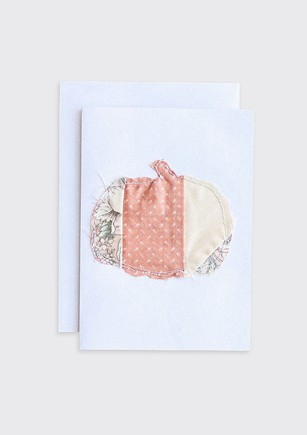 Greeting card with a colorful fabric pumpkin upcycled from quilt on a light cream background