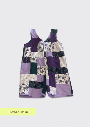 Patchwork romper / jumper with a floral and geometric pattern on a light gray background.