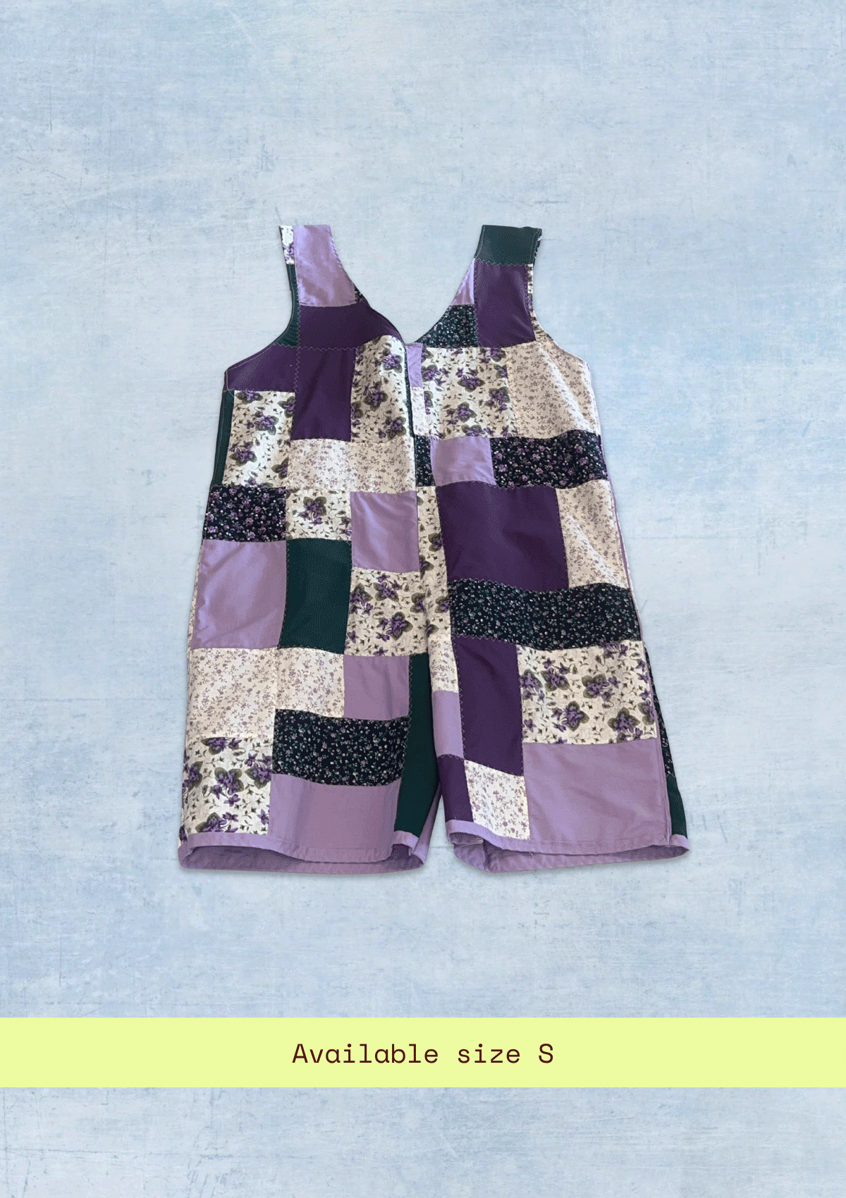 Patchwork romper / jumper with floral and geometric patterns on a light blue background