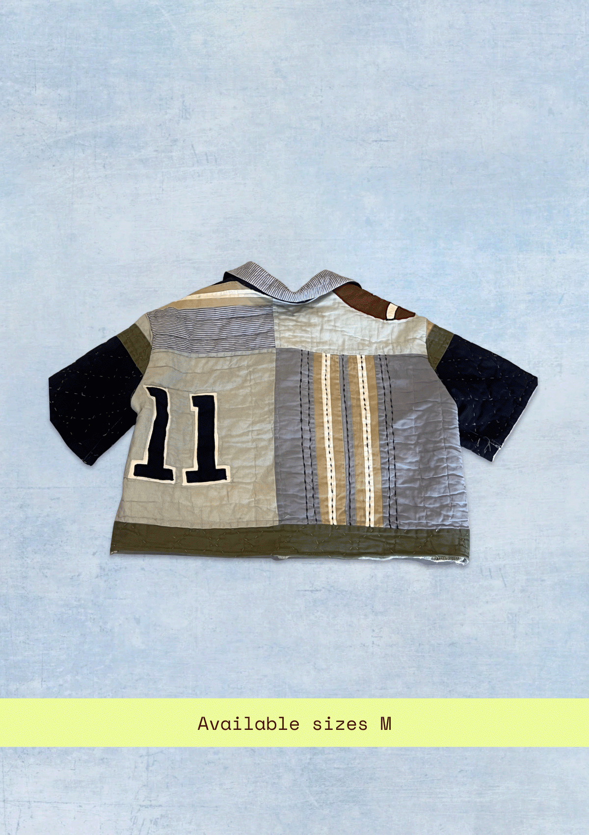 Upcycled from a quilt, a shirt with number 11 on a light blue background