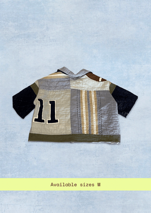 Upcycled from a quilt, a shirt with number 11 on a light blue background