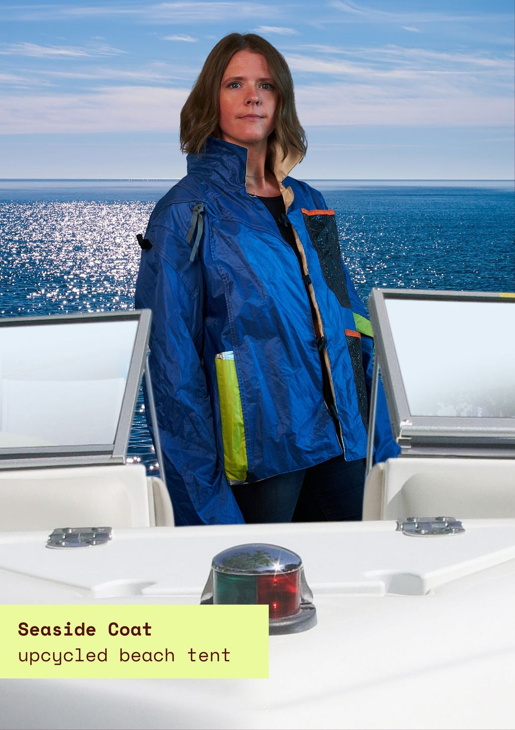 Person wearing a blue upcycled beach tent coat on a boat with ocean view