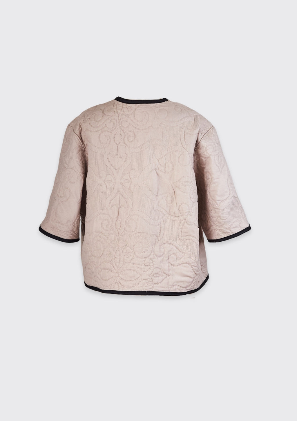 Beige quilted jacket with black trim upcycled from comforter on a white background