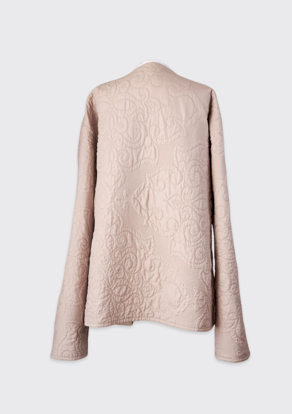 Beige textured jacket upcycled from quilt on a white background
