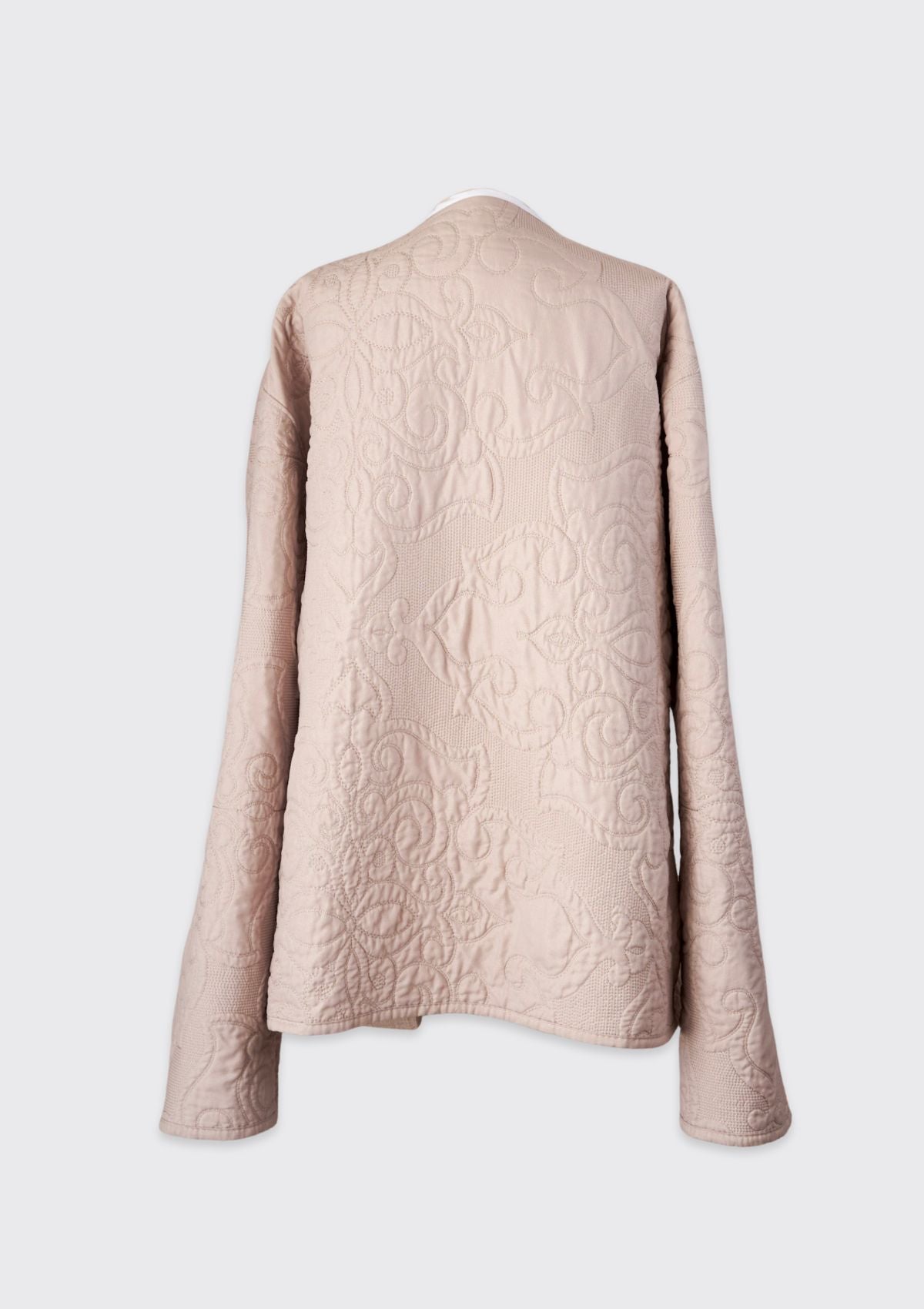 Beige textured jacket upcycled from quilt on a white background