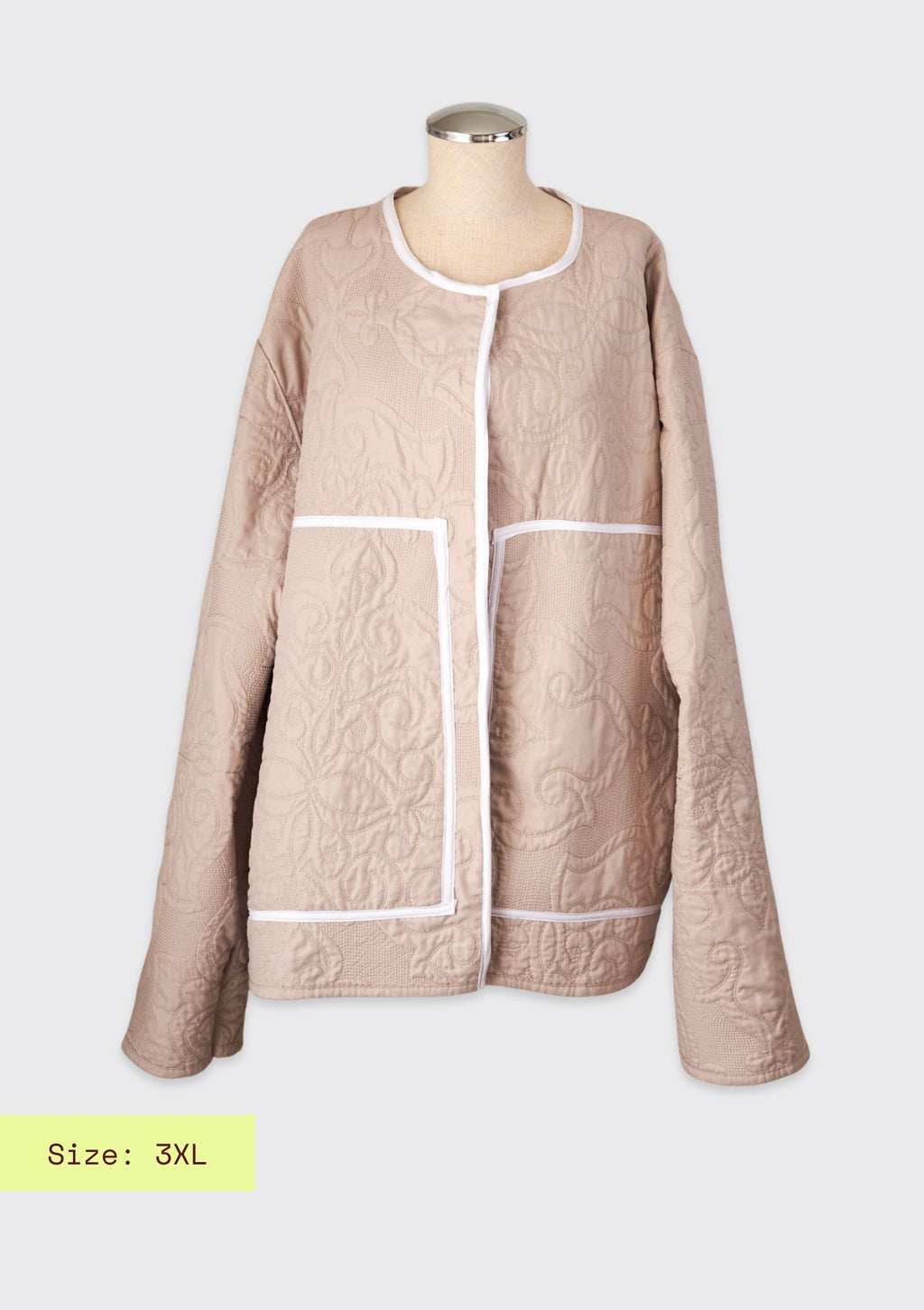 Beige quilted jacket on a mannequin against a white background