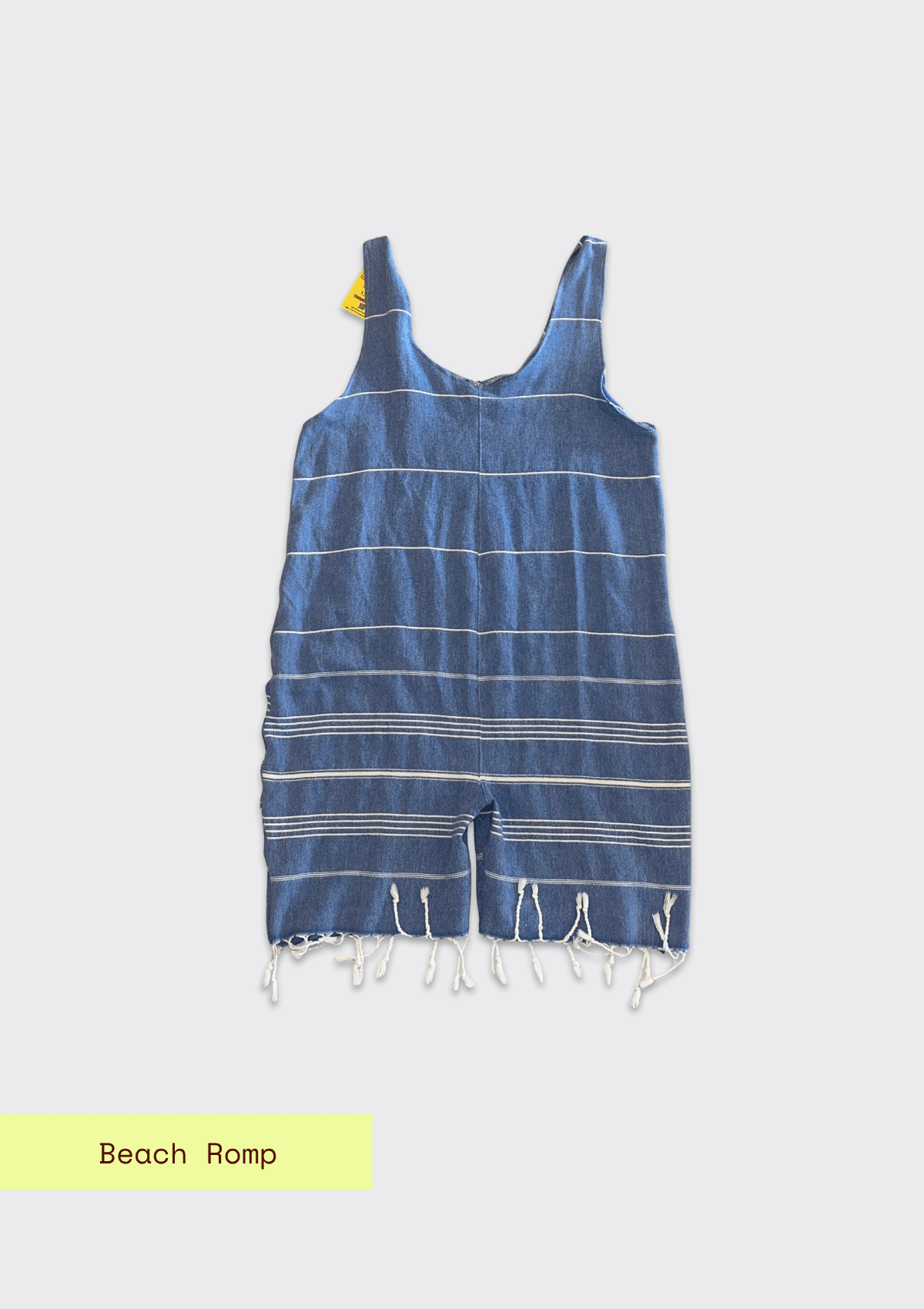 Blue striped beach romper with tassels upcycled from a turkish beach towel  on a light gray background
