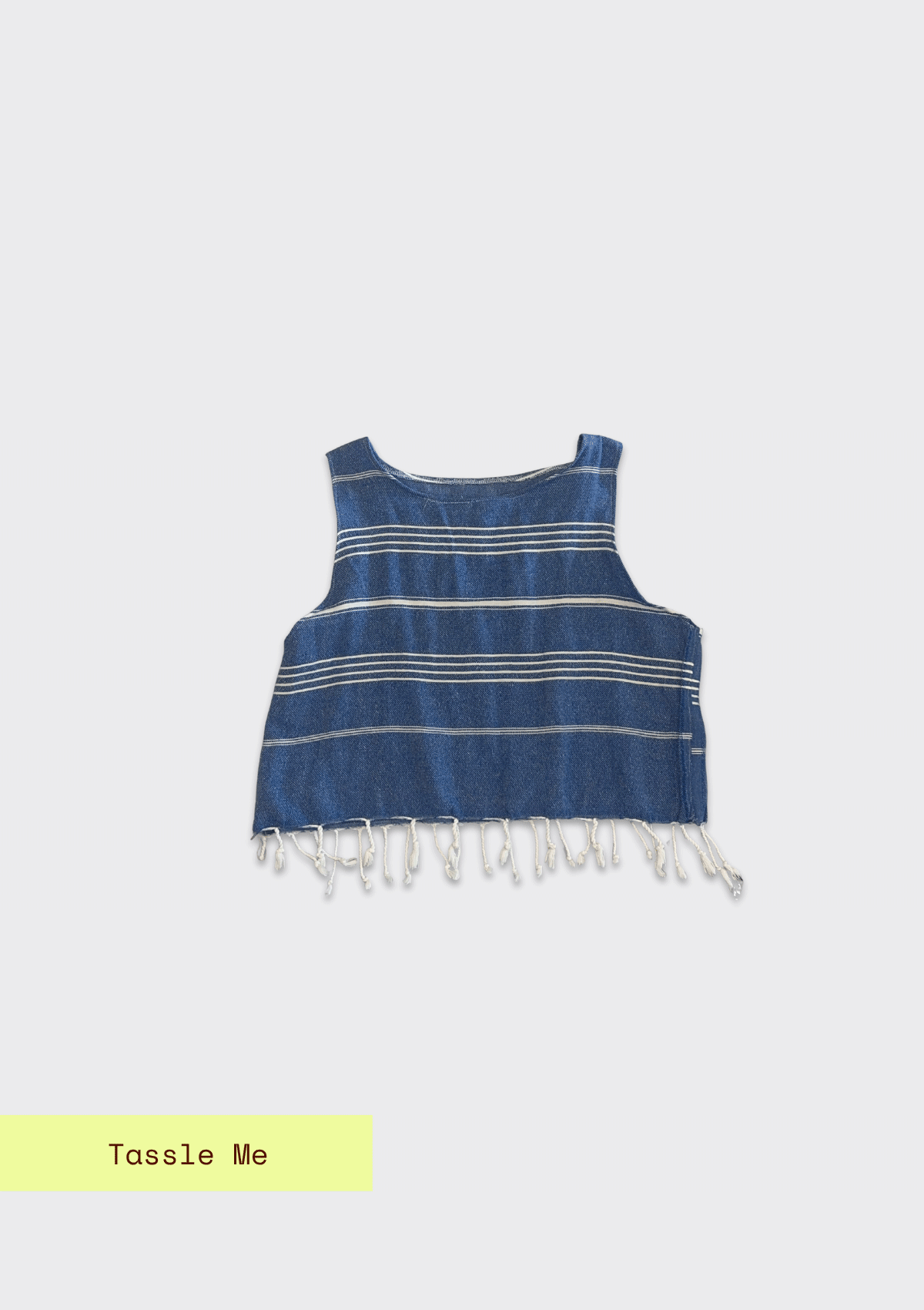 Blue sleeveless crop shirt with white fringes upcycled from a turkish towel on a light gray background