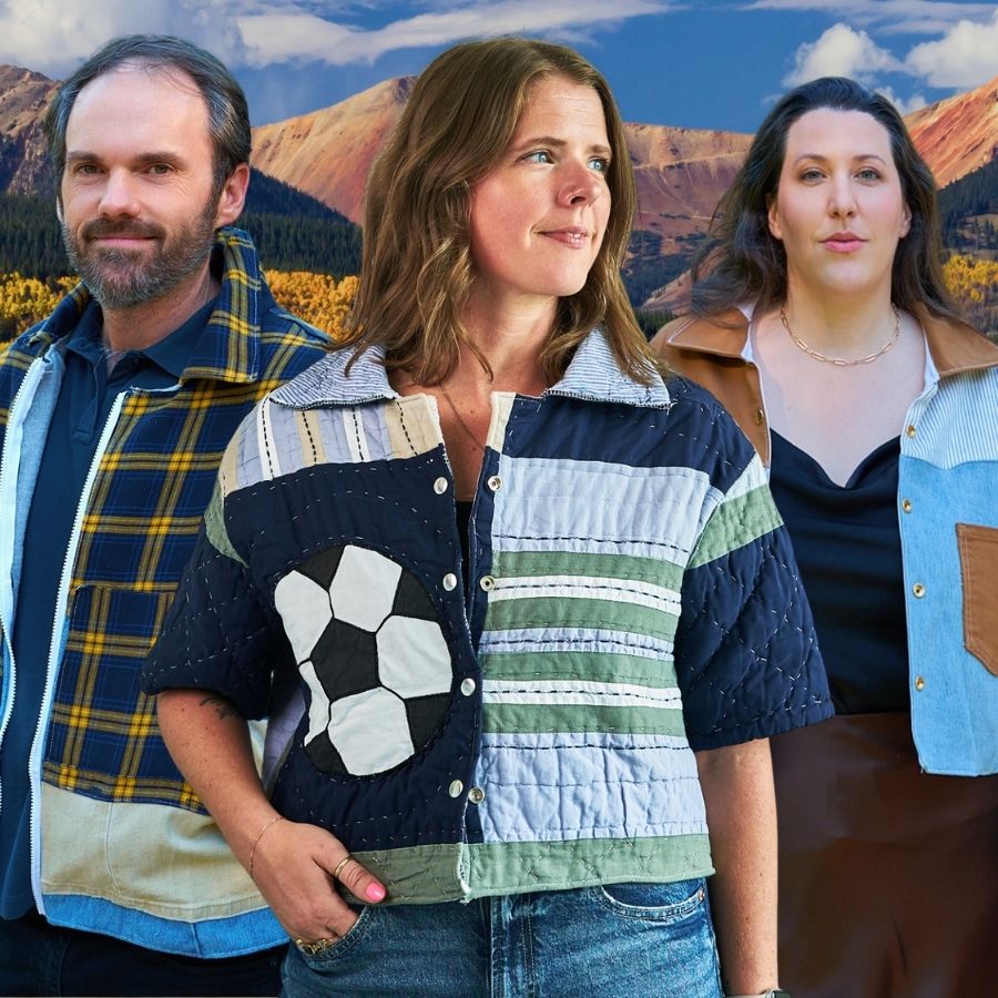Three people in upcycled jackts standing in front of a scenic mountain landscape