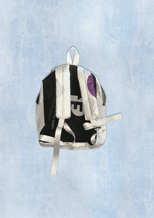 Backpack upcycled from a billboard vinyl with visible branding on a light blue textured background
