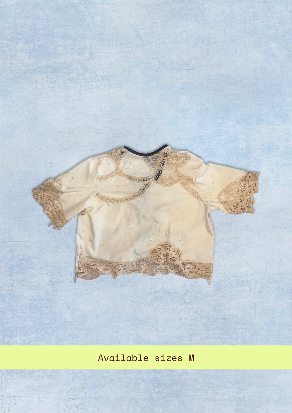 Beige lace top on a light blue background with 'Available sizes M' text.