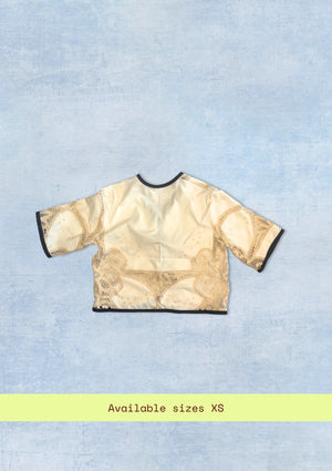 Beige lace top on a light blue textured background with 'Available sizes XS' text.