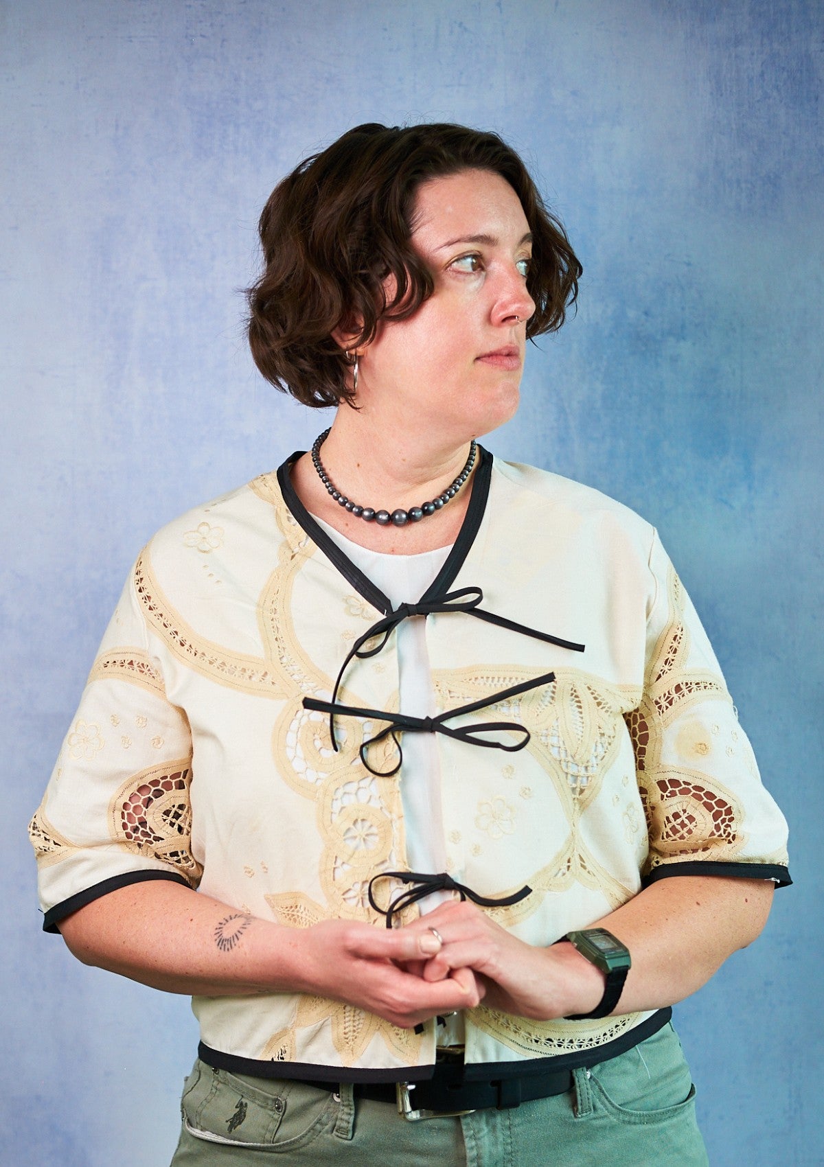 person wearing lace top with black ties upcycled from a tablecloth