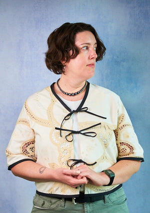 person wearing lace top with black ties upcycled from a tablecloth