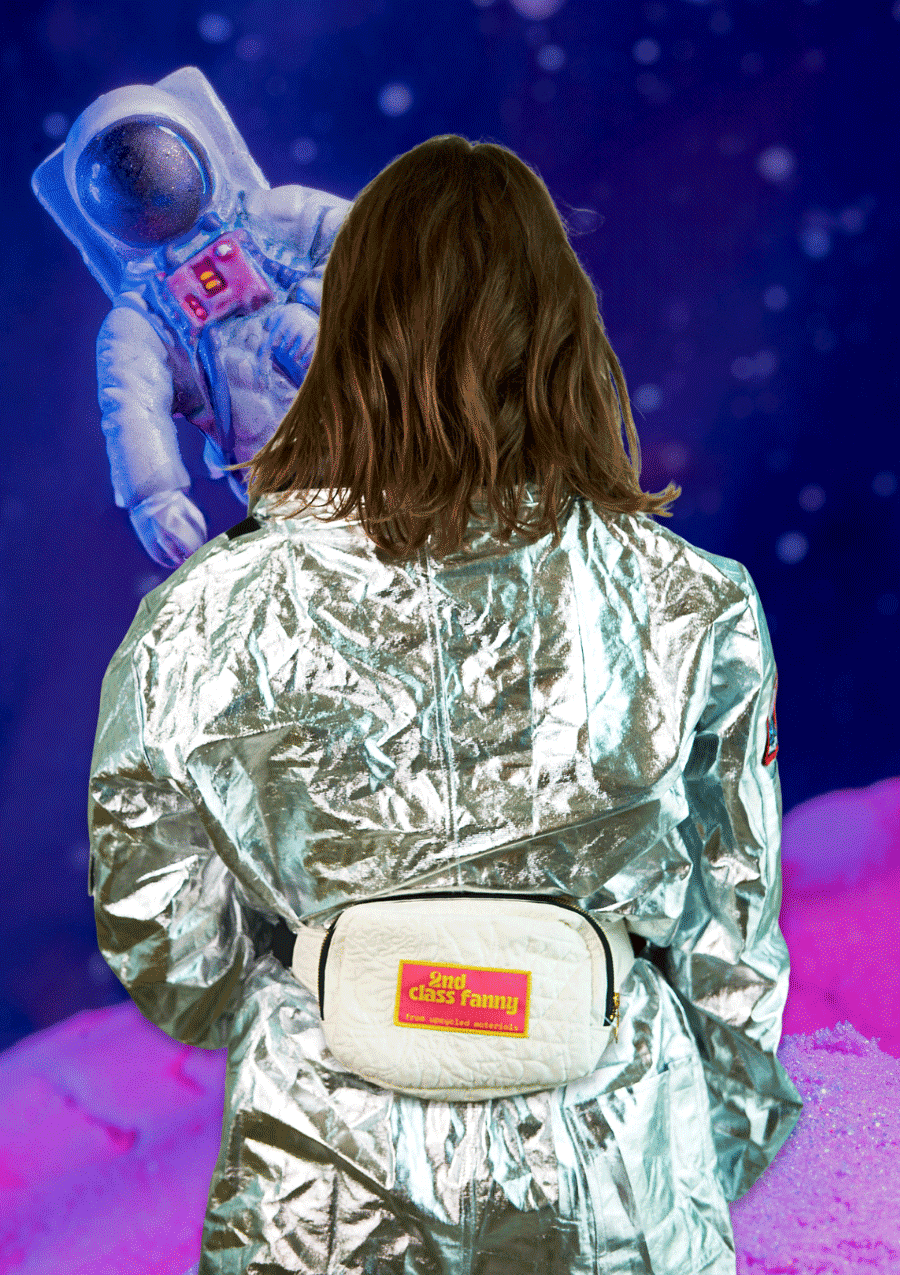 Person wearing a reflective silver jacket with a white fanny pack on waist, facing an astronaut figure against a cosmic background.