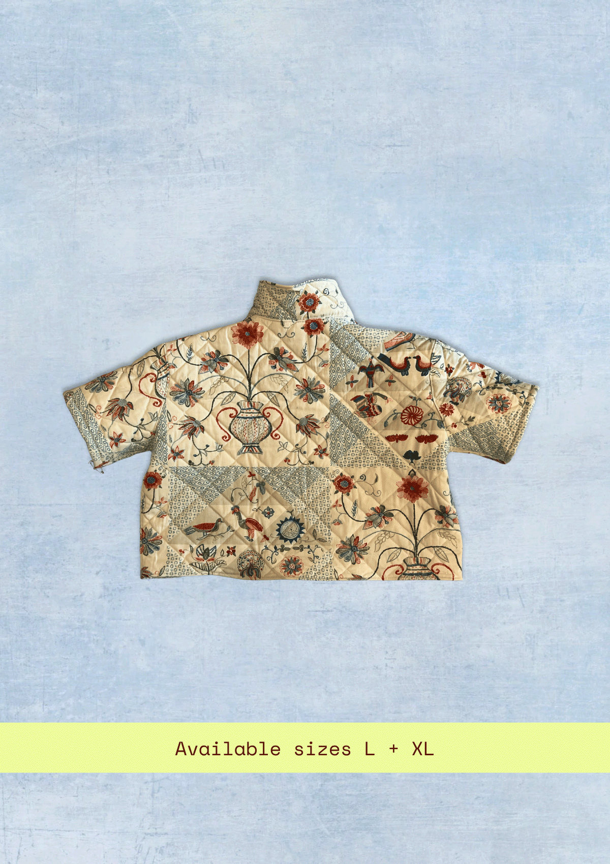 Floral patterned jacket upcycled from a quilt on a light blue background with text indicating available sizes.