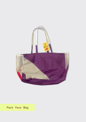 Purple and white tote bag upcycled from a windsurfing kite on a light gray background