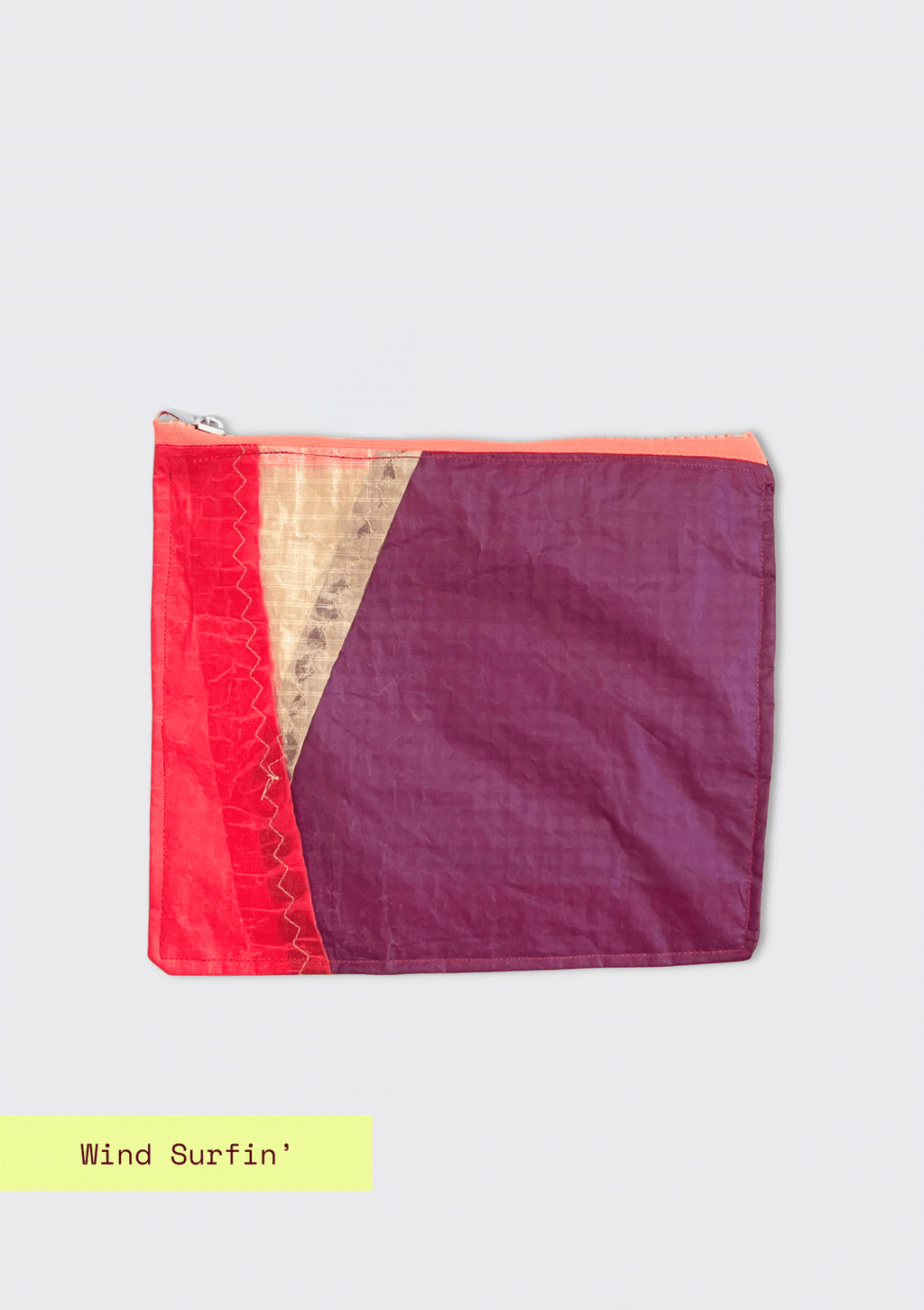 Two-tone pink and purple zipper pouch upcycled from a windsurfing kite on a light gray background