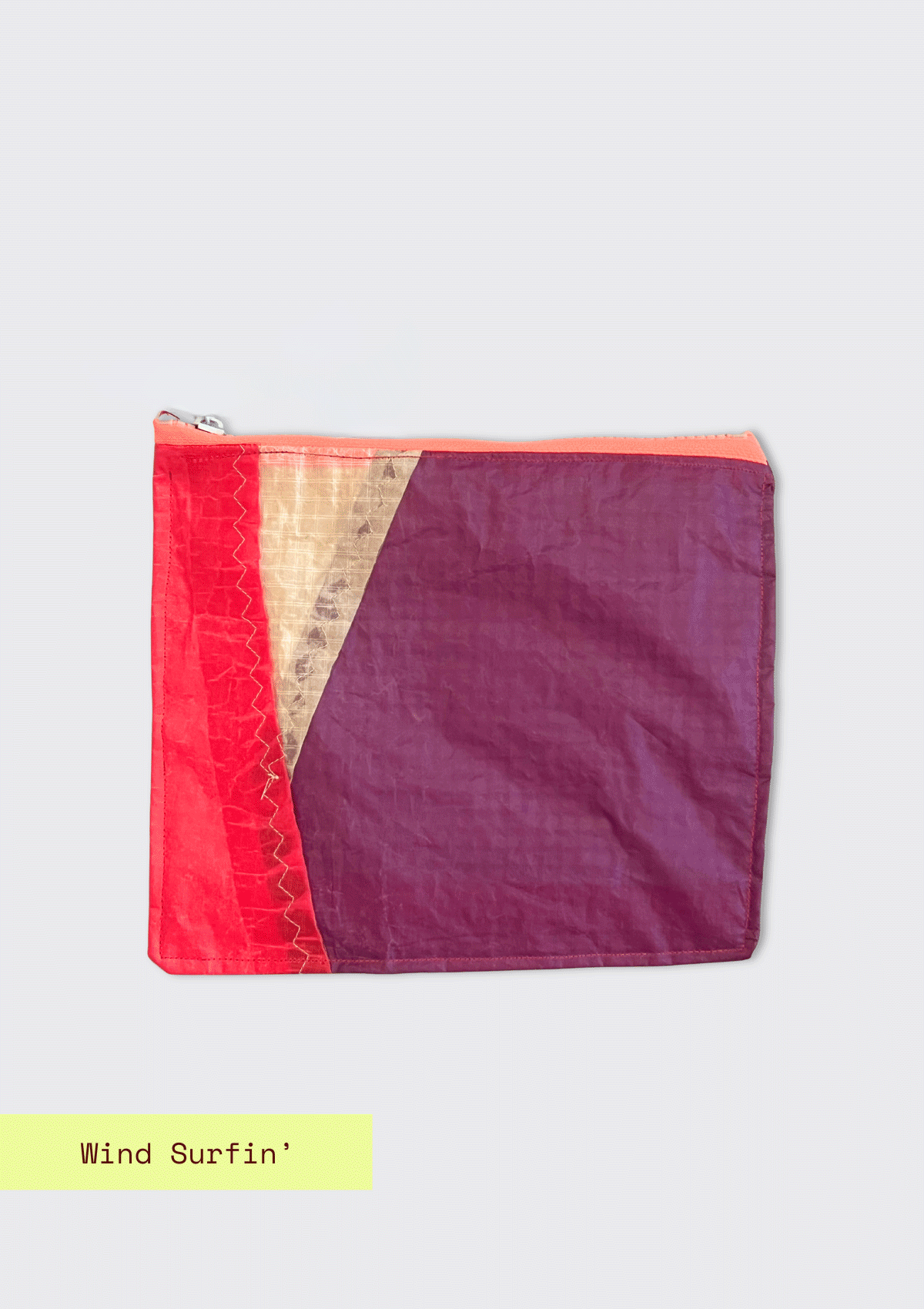 Two-tone pink and purple zipper pouch upcycled from a windsurfing kite on a light gray background