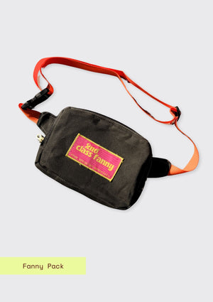 Black fanny pack with orange strap upcycled from wax canvas on a light gray background