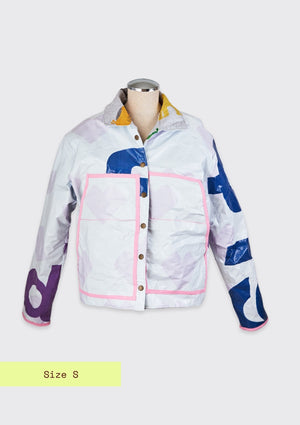 White coat ucpcyled from billboard with pink lined front pockets on a grey background