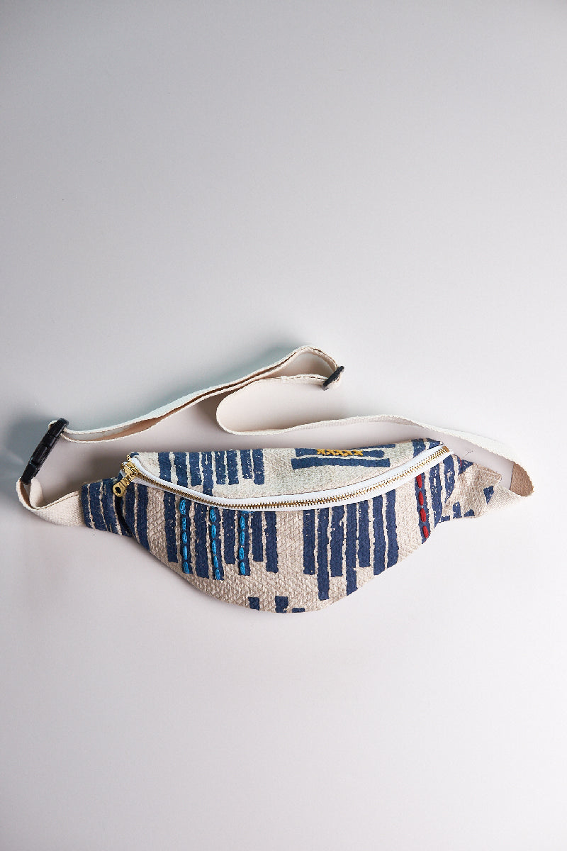 Fanny pack with blue and white pattern on a light gray background