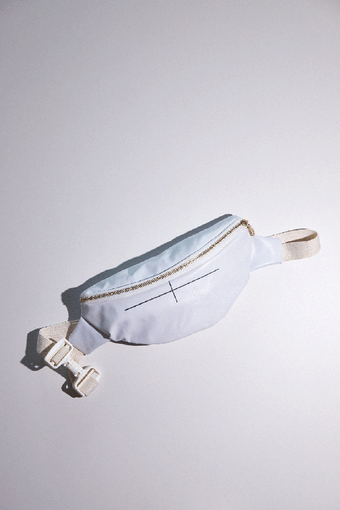 White waist bag with gold zipper on a light gray background