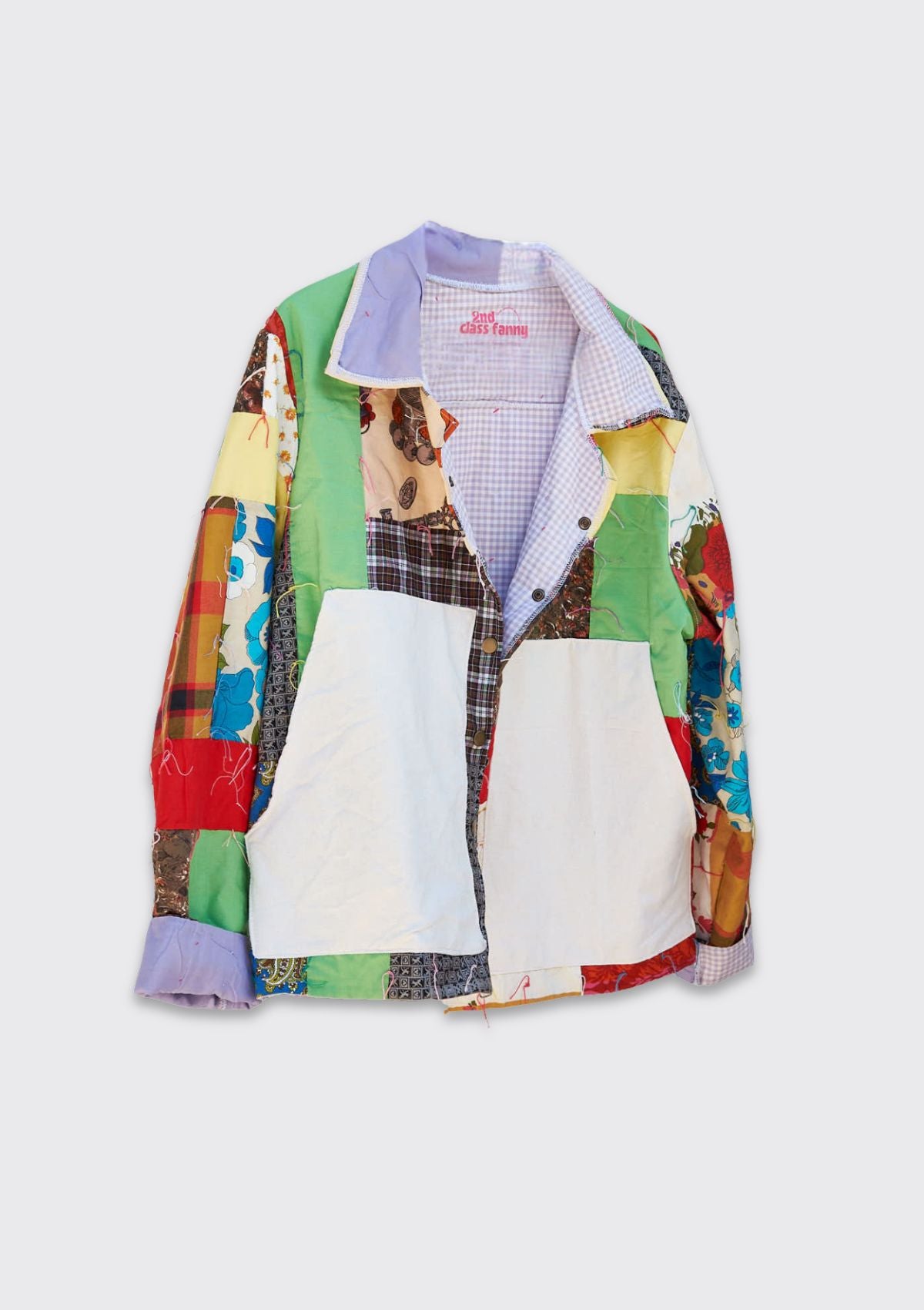 Upcycled quilt turned into a colorful patchwork jacket on a white background
