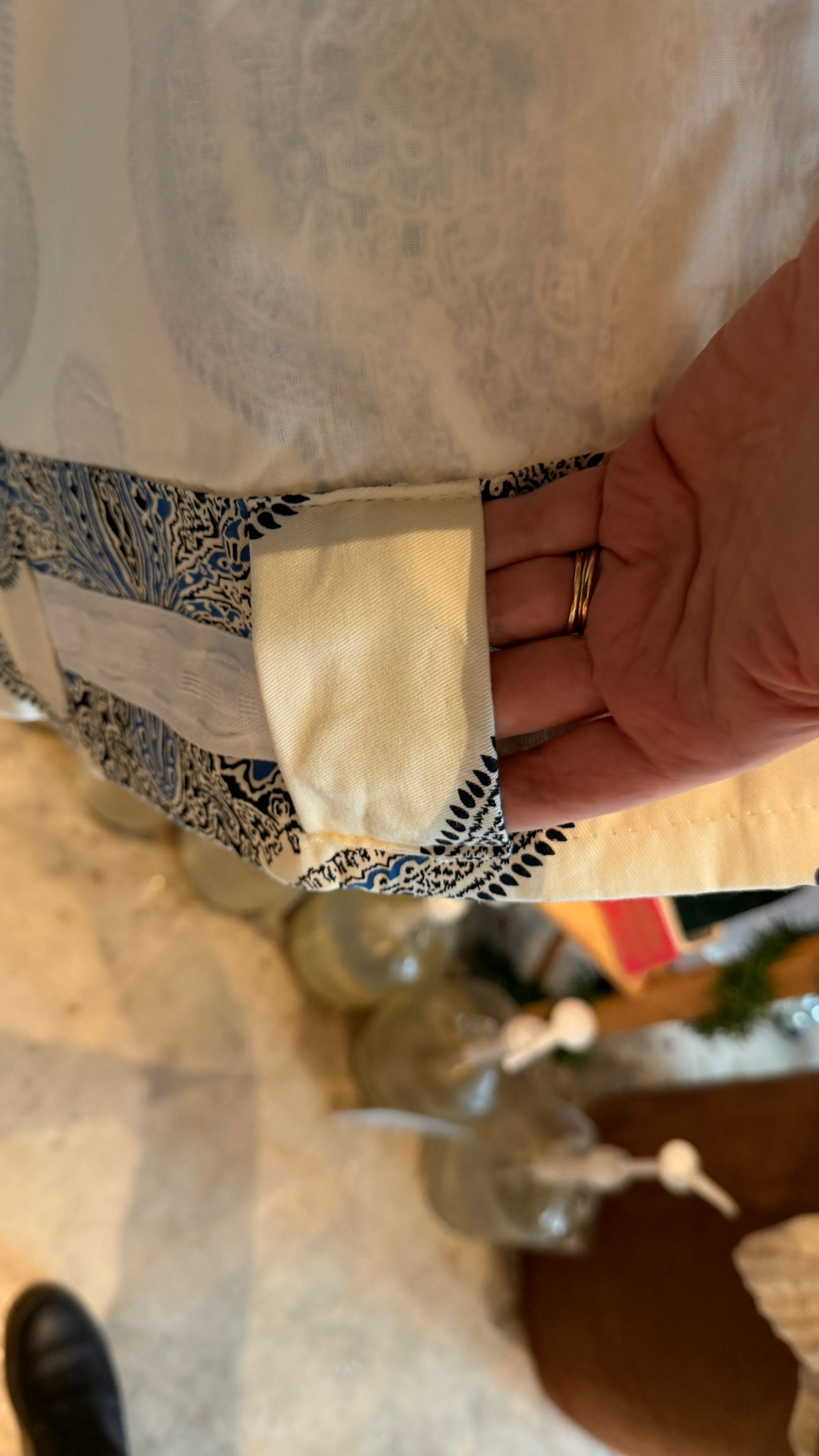 Close-up of a person holding a piece of fabric upcycled from a curtain.