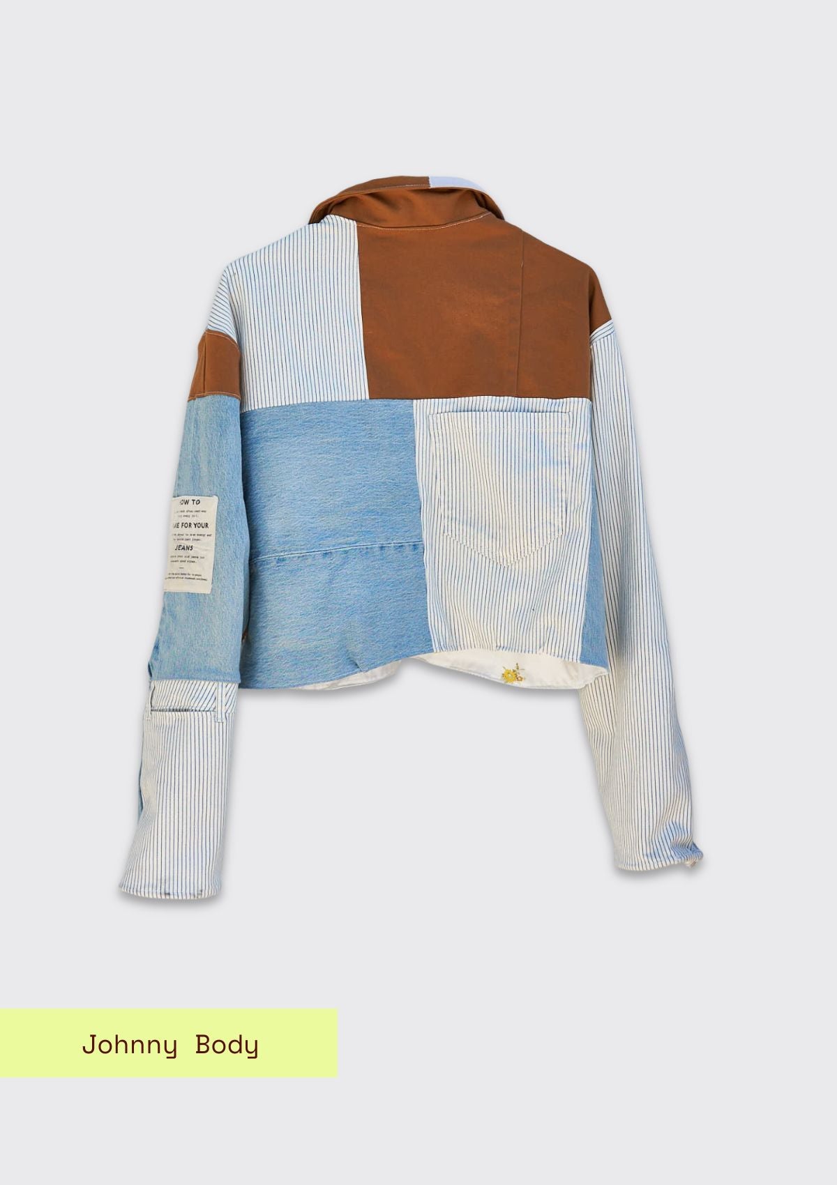 Color-blocked jacket with brown, blue, and white denim sections made from upcycled denim jeans on a light gray background.