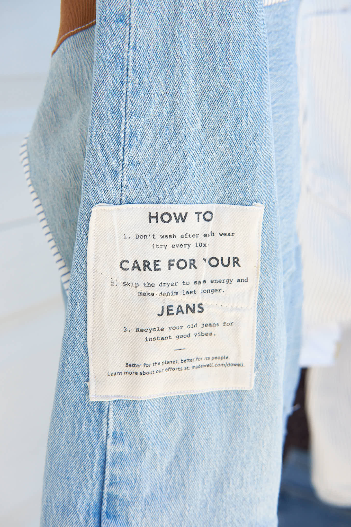Care label instructions tag on the jacket sleeve. Upcycled from denim jeans. 