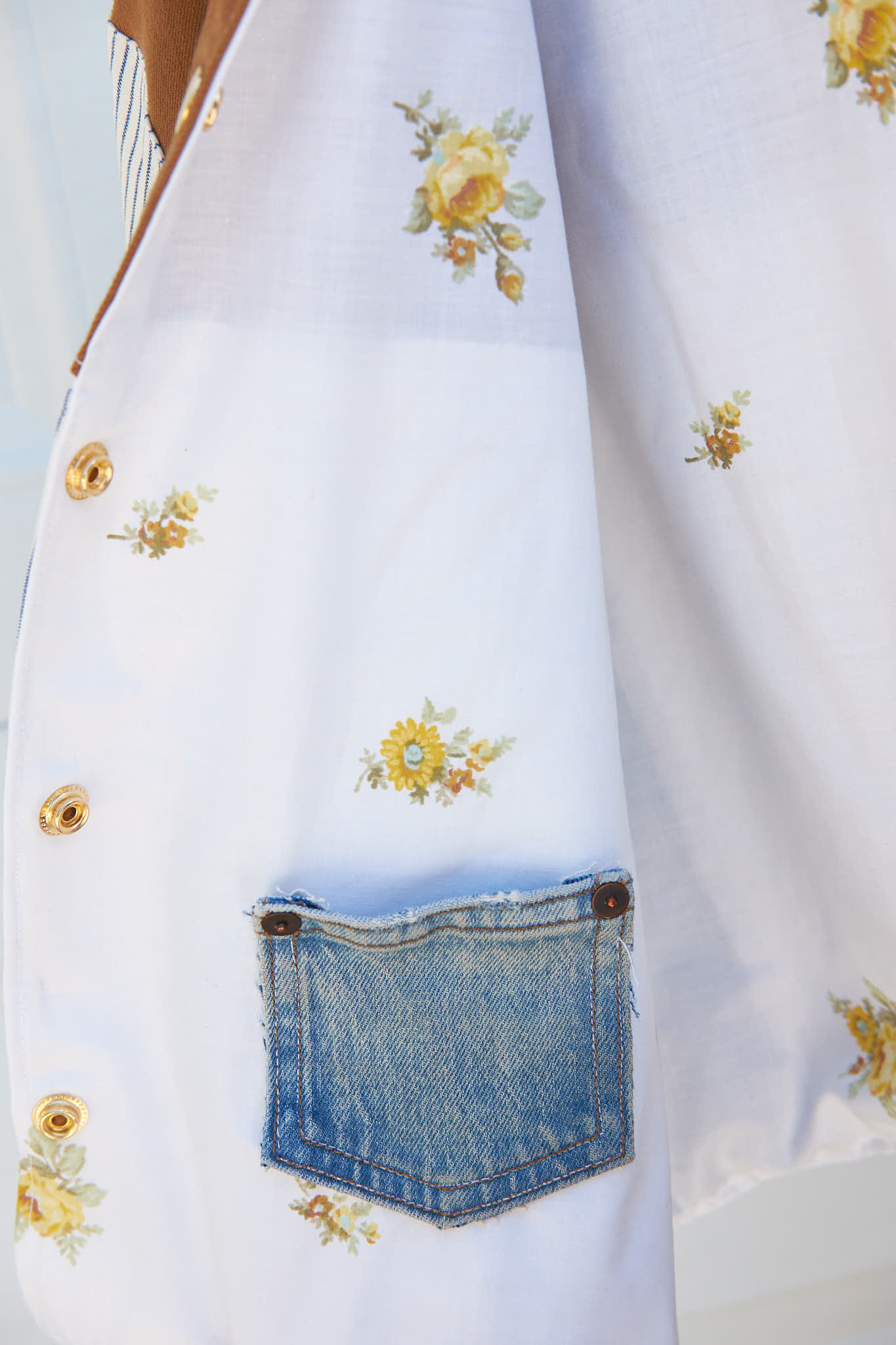 Floral pattern jacket lining with a denim pocket upcycled from a bed sheet and denim jeans.