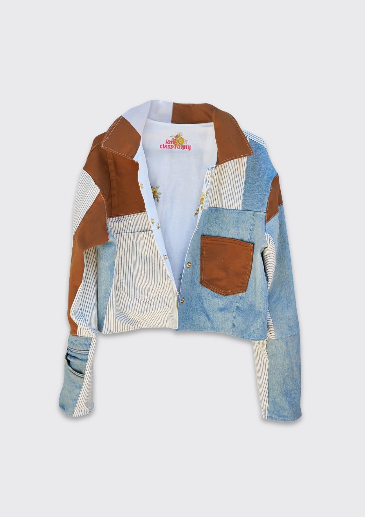 Patchwork denim jacket with upcycled from denim jeans on a light gray background.