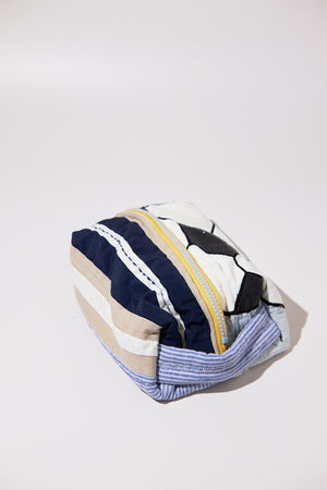 Striped pouch with a zipper and soccer ball upcycled from quilt on a white background